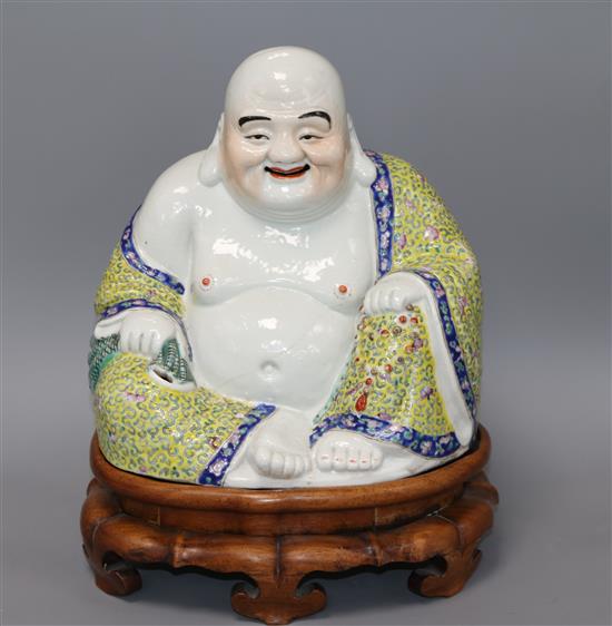 A Chinese enamelled porcelain figure of Budai, wood stand, Guangxu overall height 35cm
